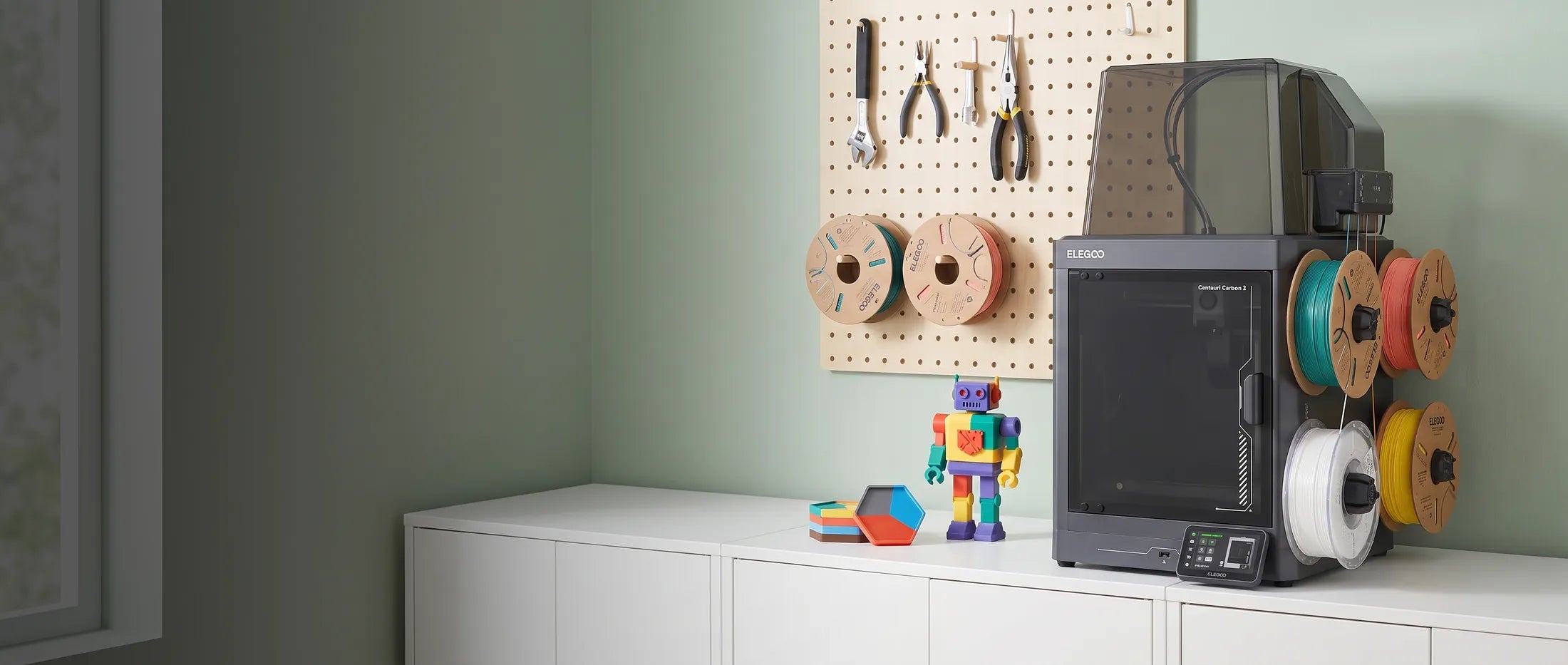 Elegoo Centauri Carbon 2 Combo 3D printer with its filament rack on a white sideboard