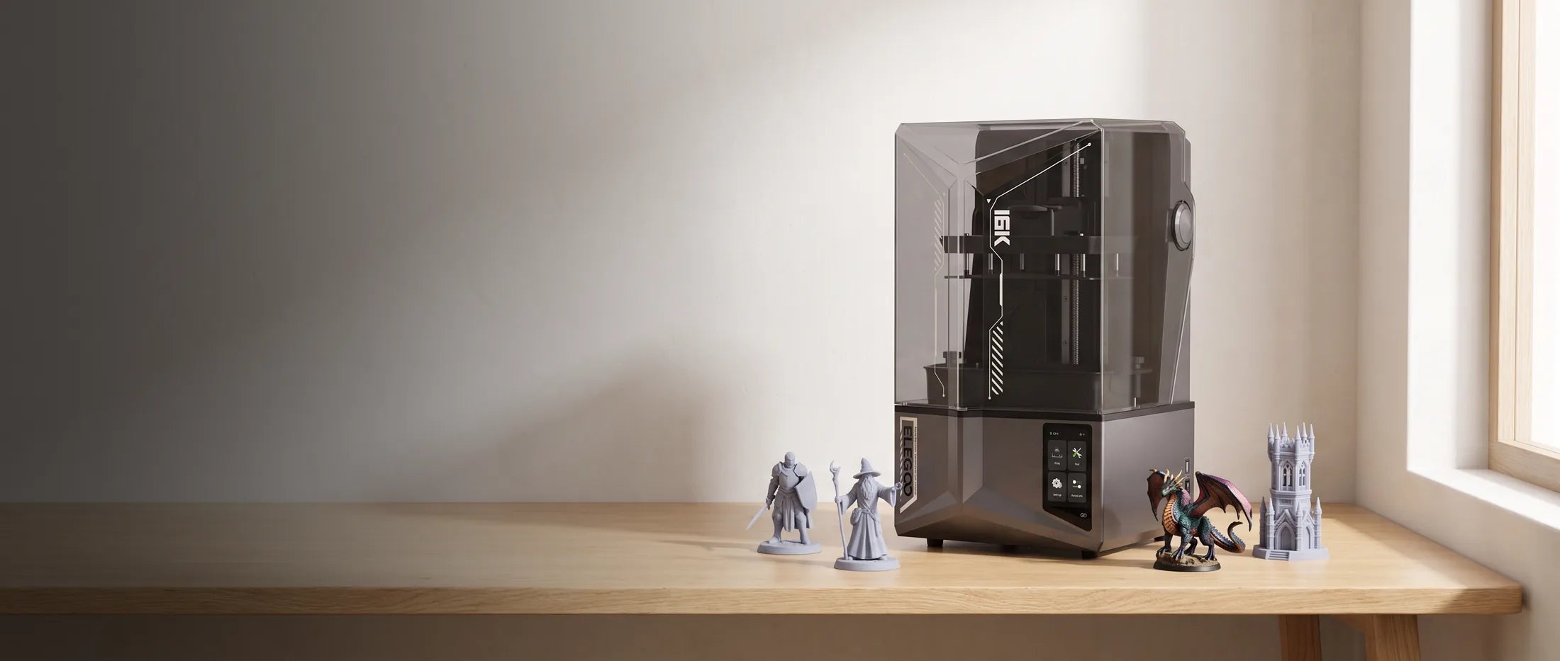 Elegoo Saturn 4 Ultra 16K resin 3D printer on a desk with printed miniatures